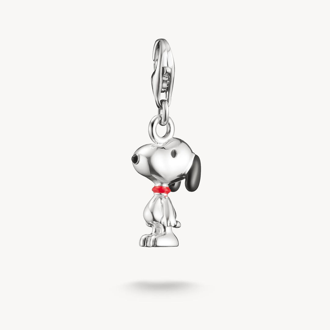 Silver dog charm with a red collar on a white background