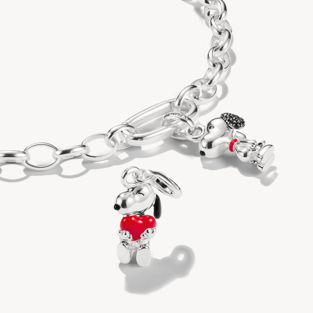 Silver bracelet with two dog-shaped charms on a white background