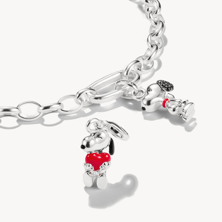 Silver bracelet with two dog-shaped charms on a white background