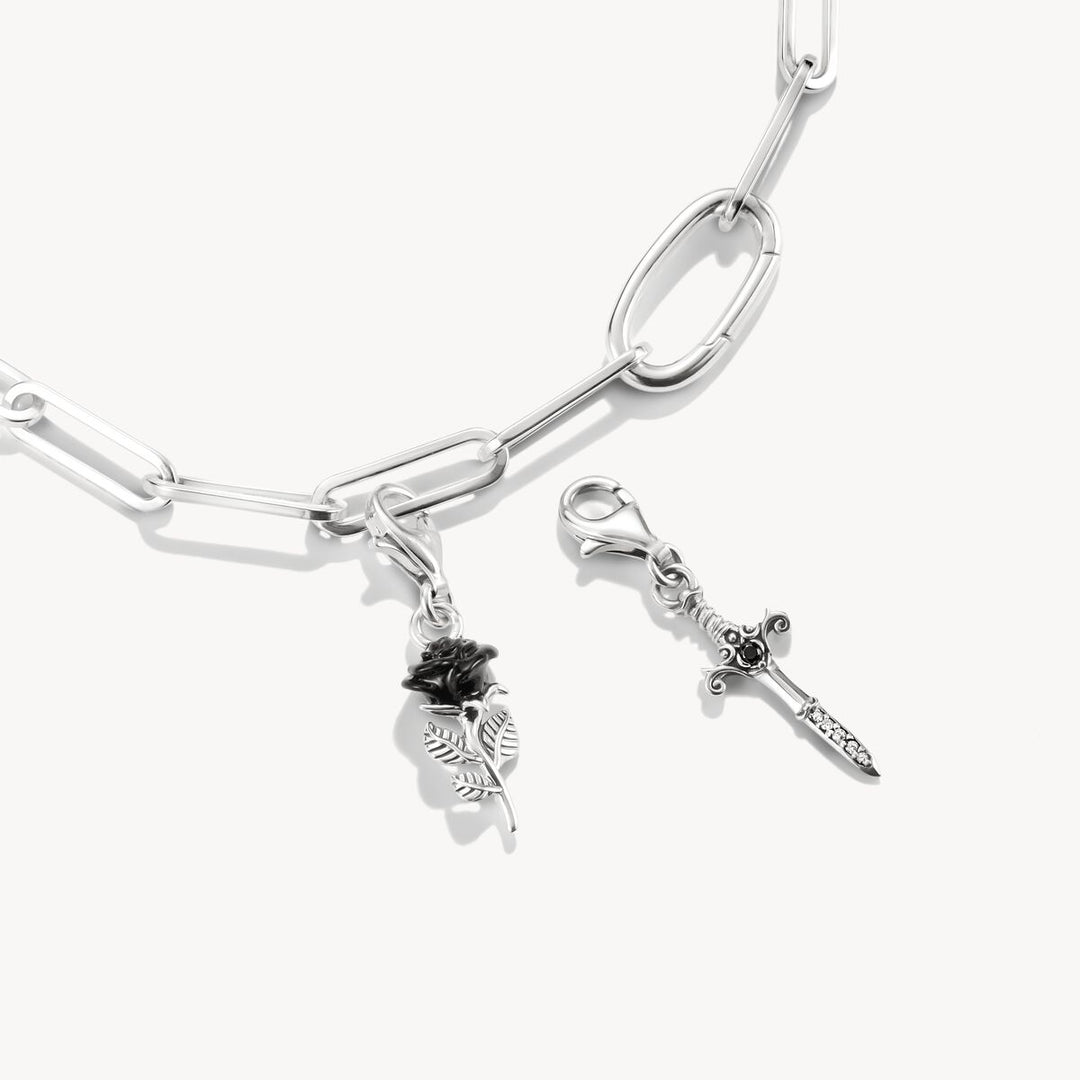 Silver bracelet with charms on a white background