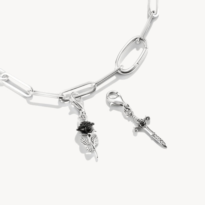 Silver bracelet with charms on a white background