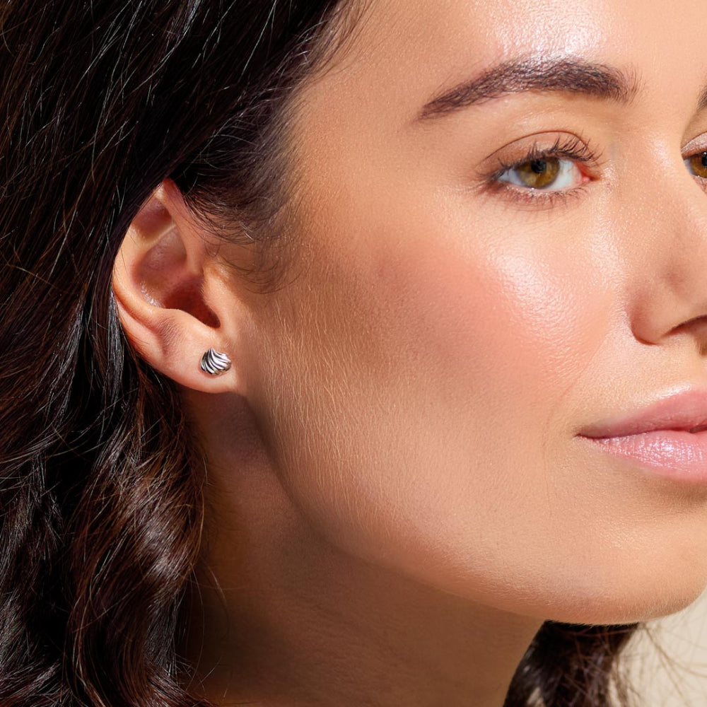 Close-up of a woman's face with a focus on her earring.