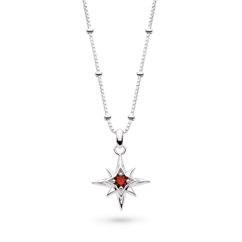 Silver necklace with a star-shaped pendant featuring a red gemstone on a white background
