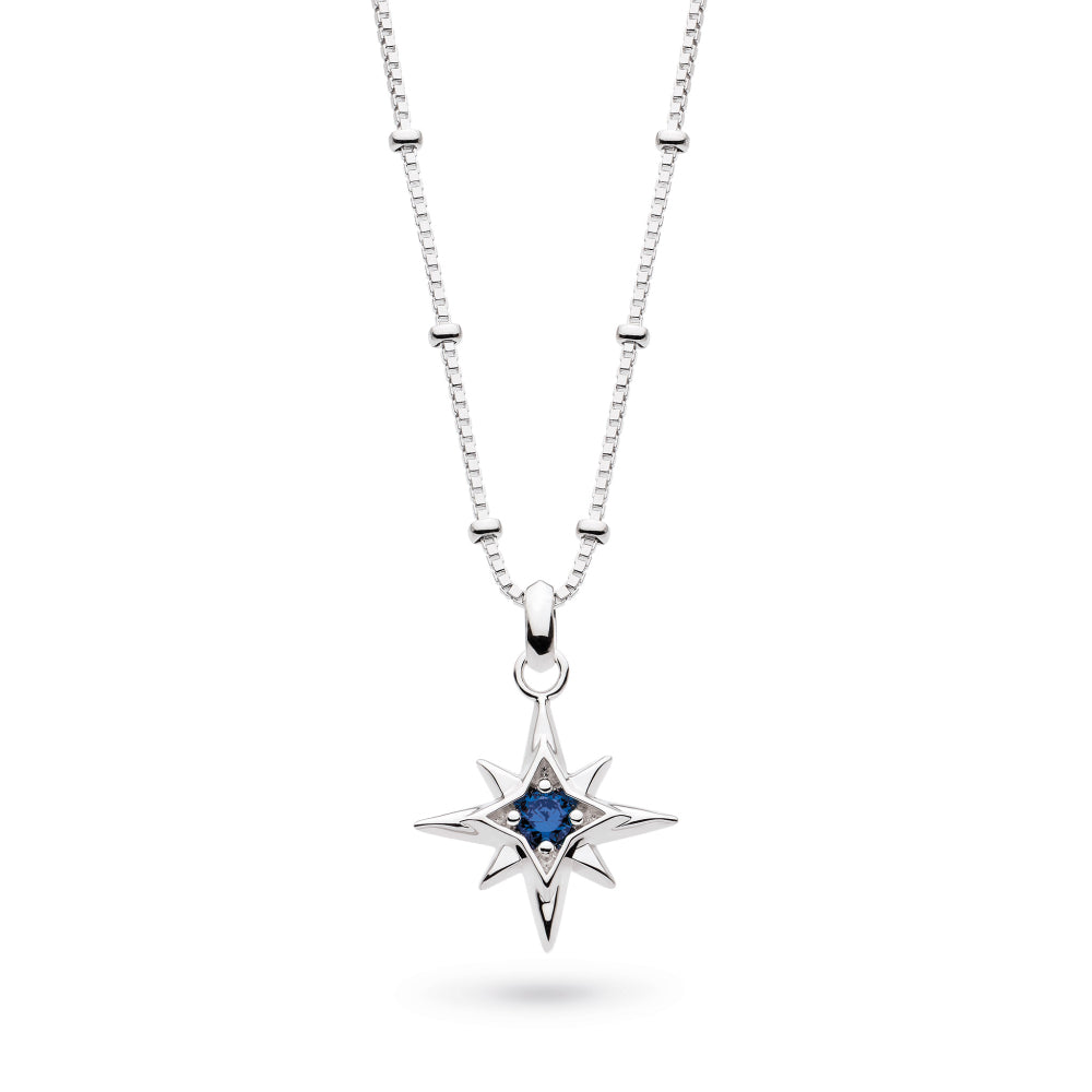 Silver necklace with a star-shaped pendant featuring a blue gemstone on a white background