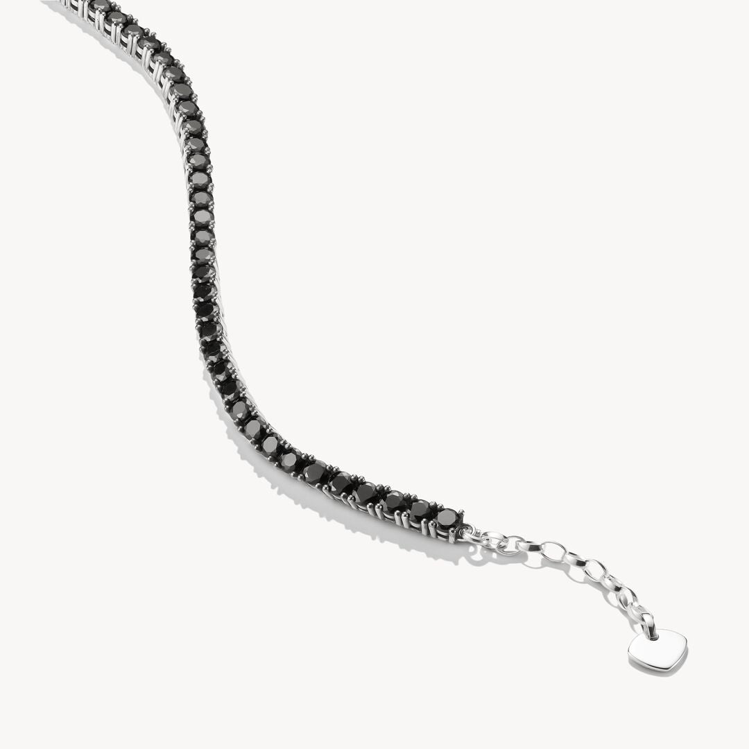Silver bracelet with black stones on a white background