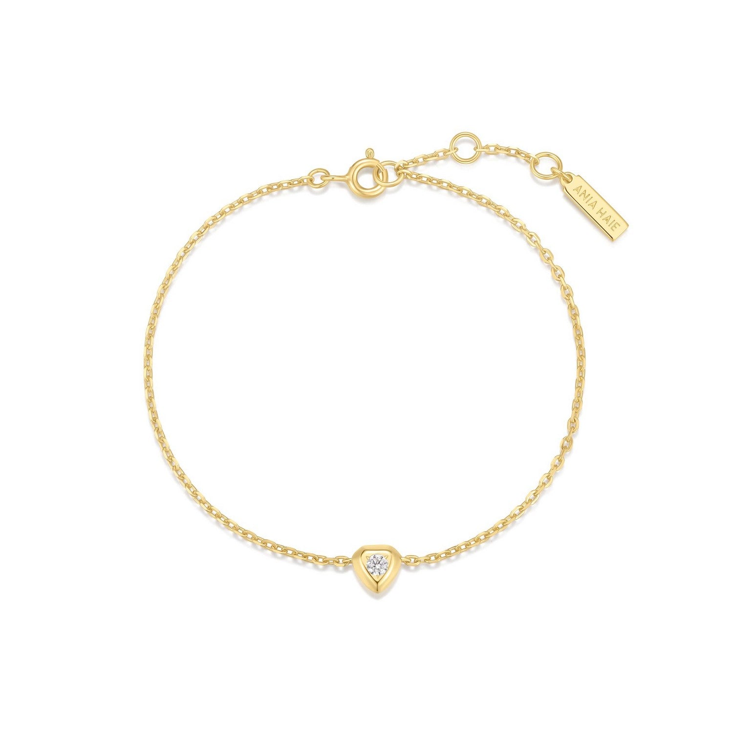 Gold bracelet with a heart-shaped diamond charm on a white background