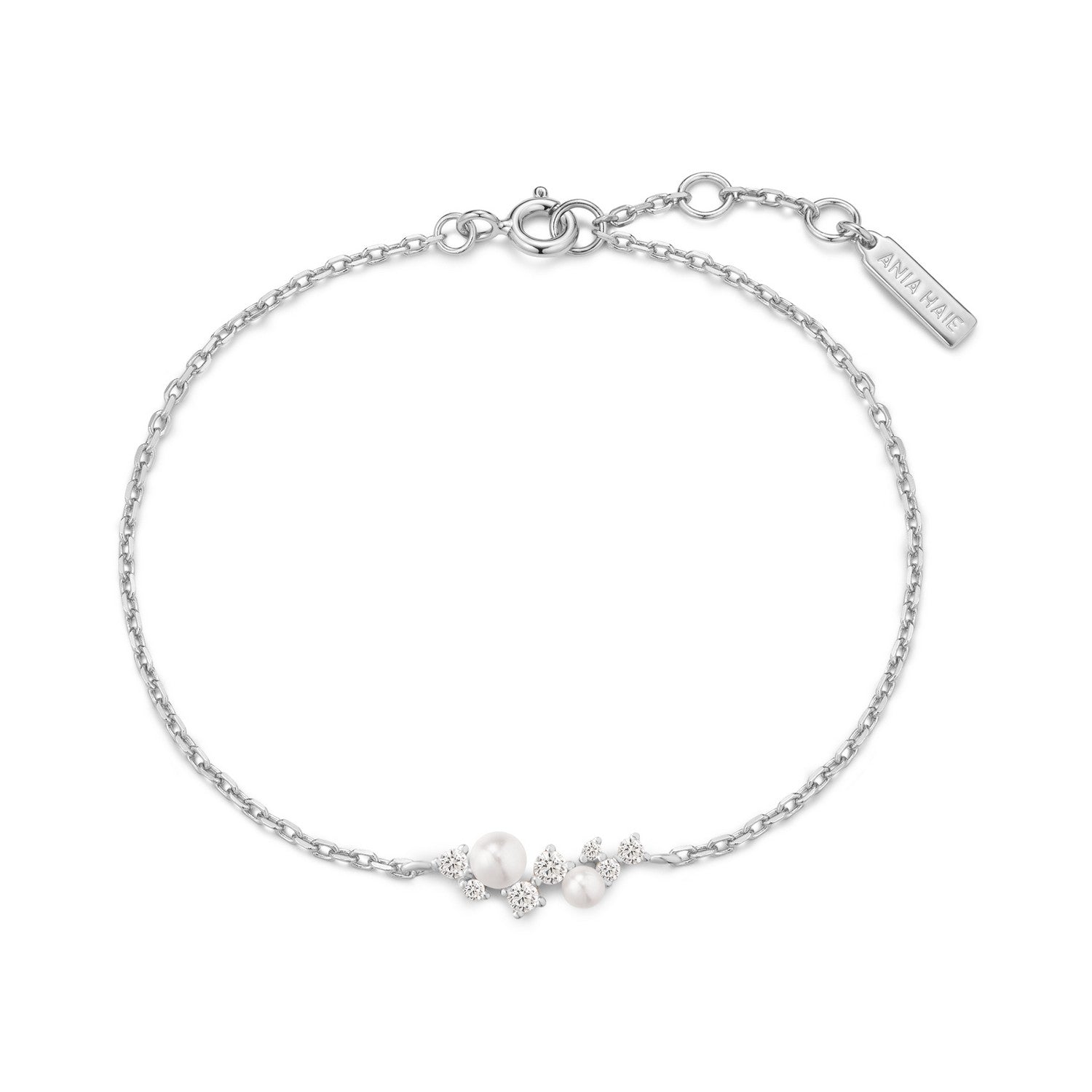 Silver bracelet with small pearls on a white background