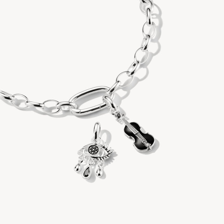 Silver bracelet with two charms on a white background