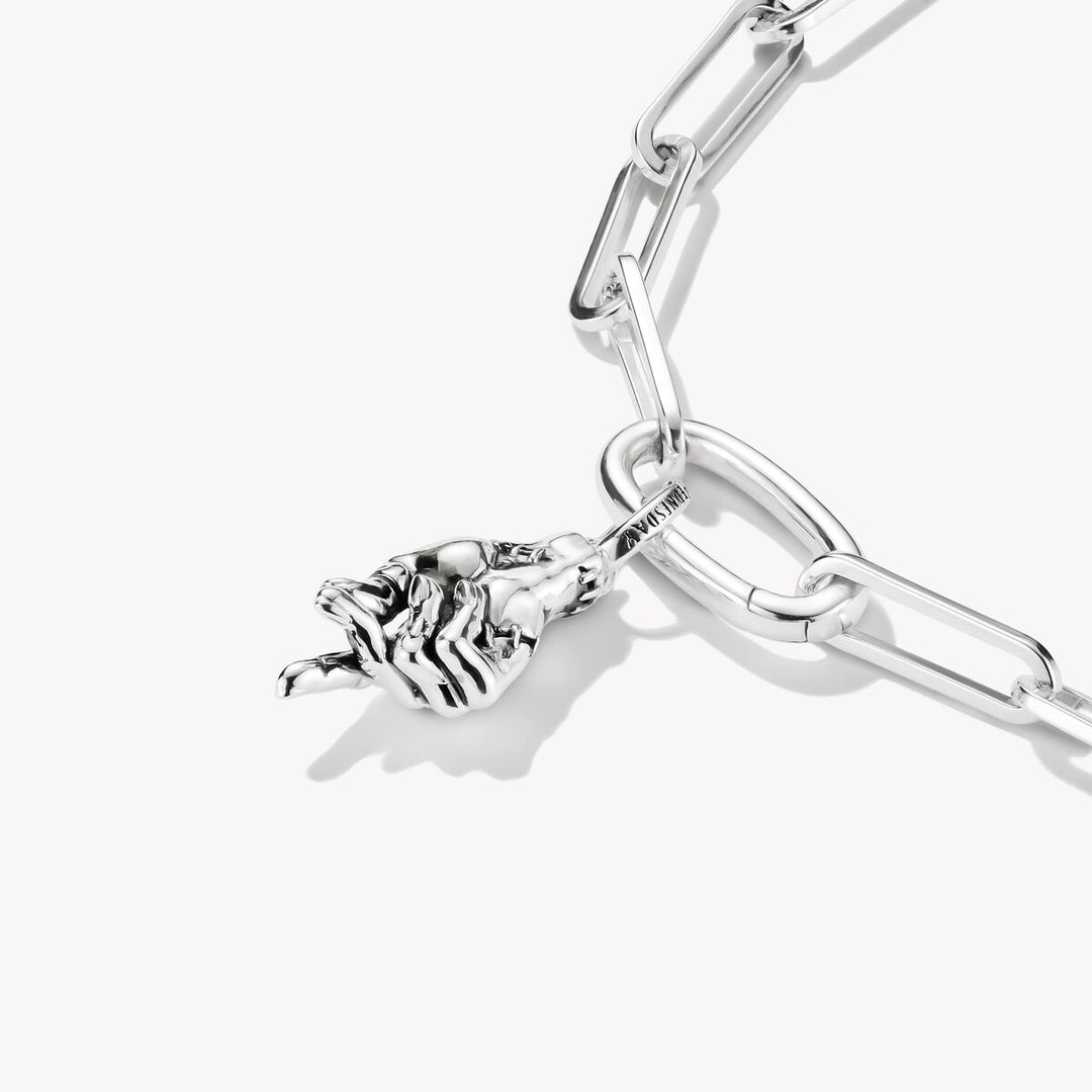Silver bracelet with a rose charm on a white background