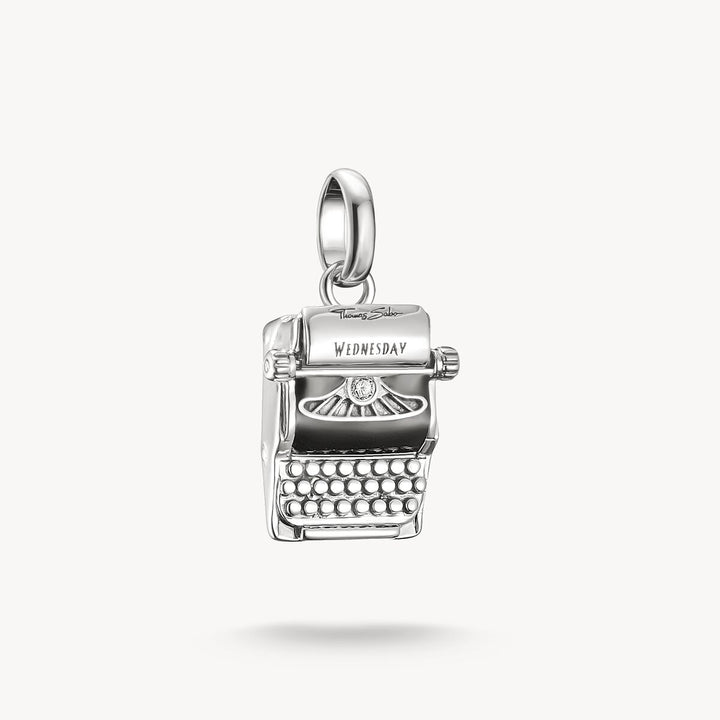 Silver typewriter charm with 'Wednesday' on a white background