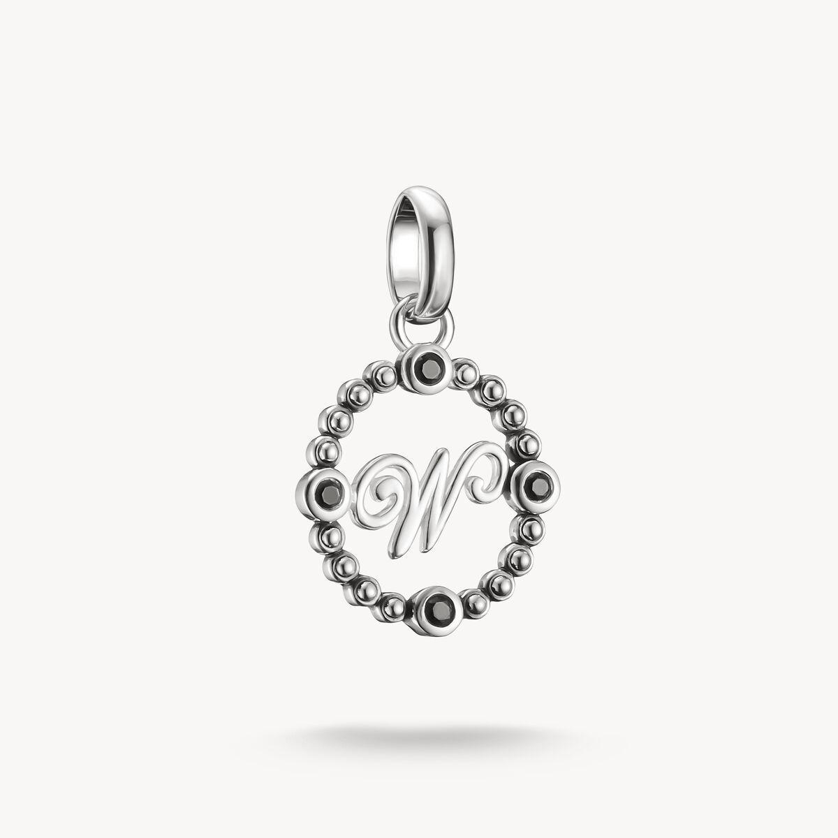 Silver pendant with letter 'W' on a white background