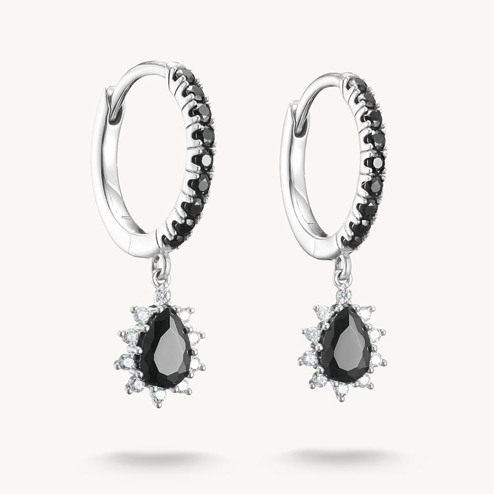 Pair of hoop earrings with black teardrop gemstones on a white background