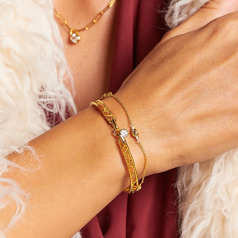 Gold bracelet on a wrist