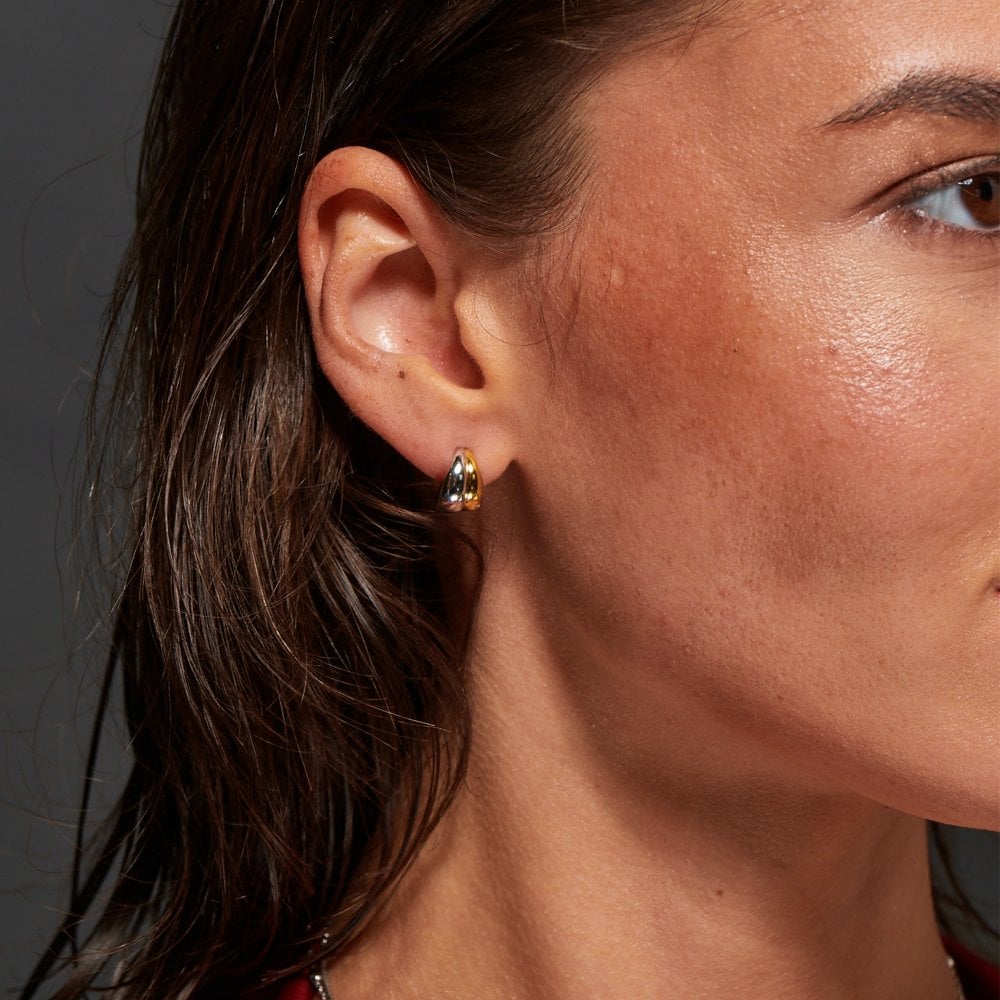 Close-up of a woman wearing gold hoop earrings