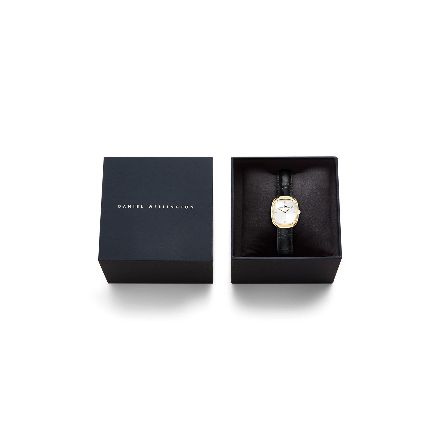 Daniel Wellington wristwatch with a gold oval bezel and white dial, presented in an open black gift box next to its closed lid on a white background.