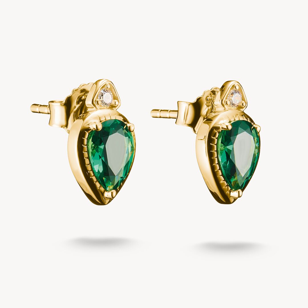 Gold earrings with green gemstones on a white background
