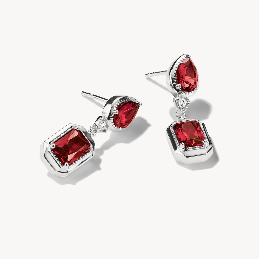 Pair of red gemstone earrings on a white background