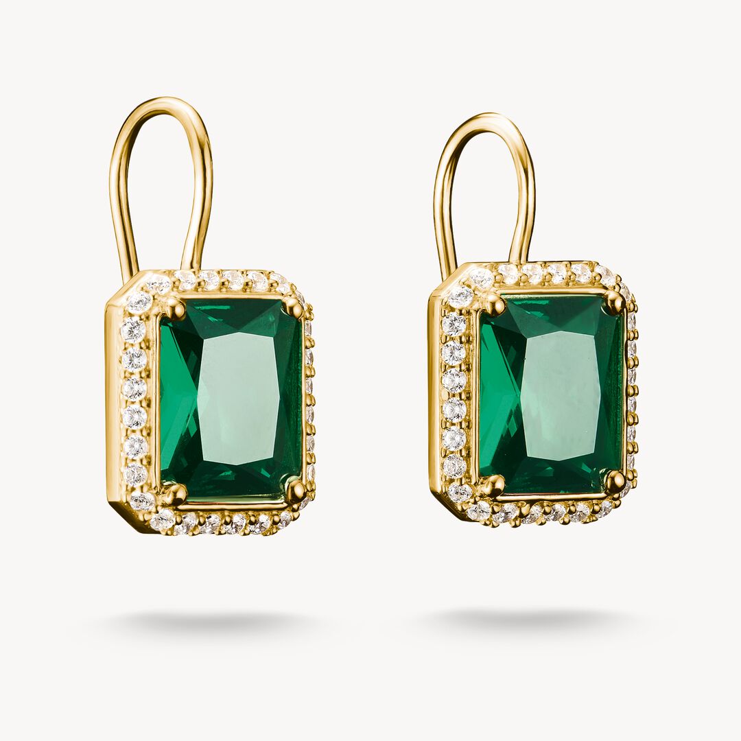 Gold earrings with green gemstones on a white background