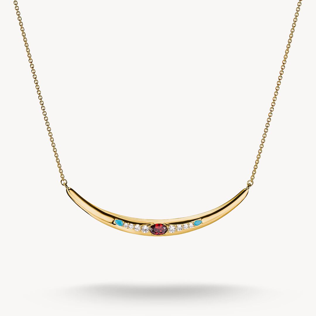 Gold necklace with gemstones on a white background