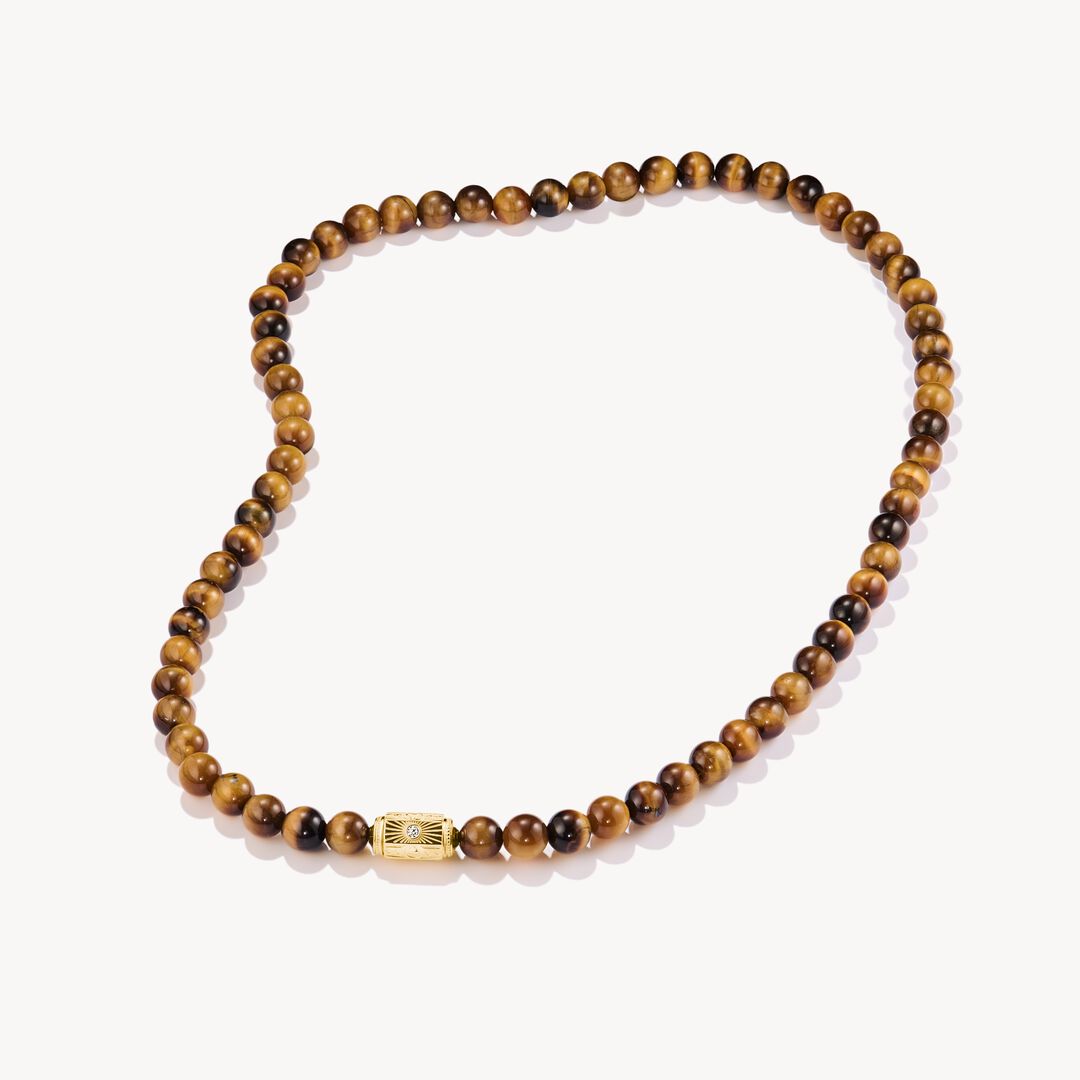 Wooden beaded necklace with a gold clasp on a white background