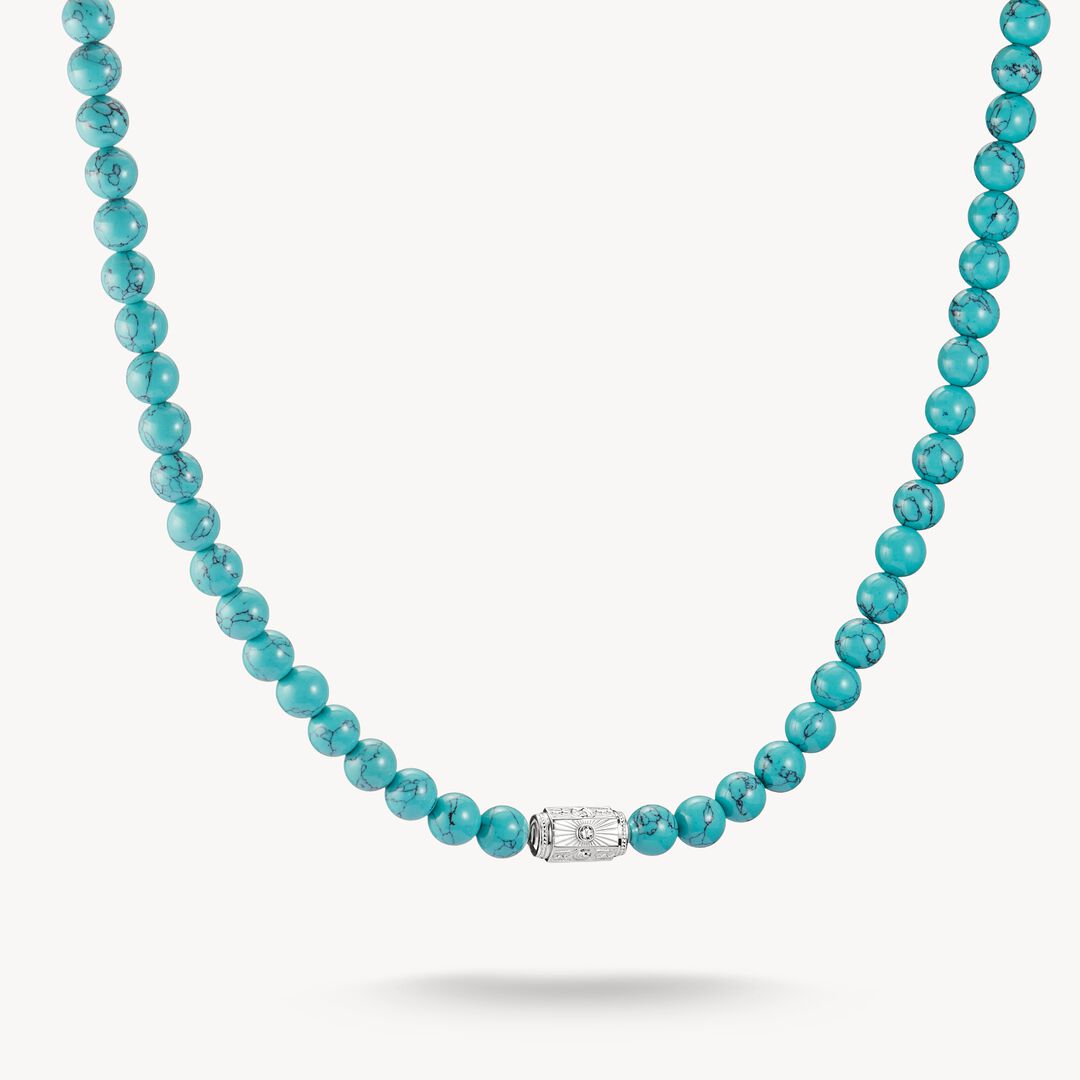 Turquoise beaded necklace with a silver clasp on a white background