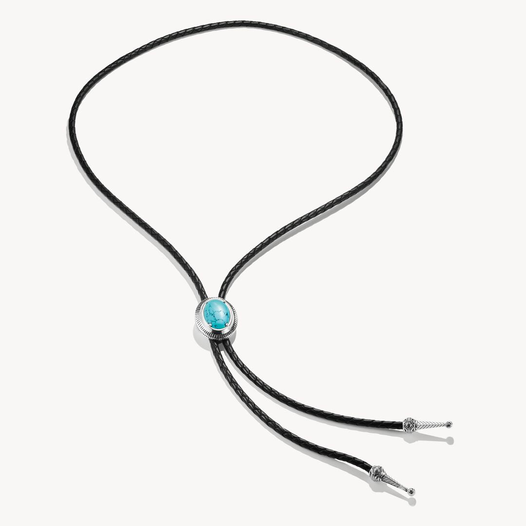 Bolo tie with turquoise stone and black cord on a white background