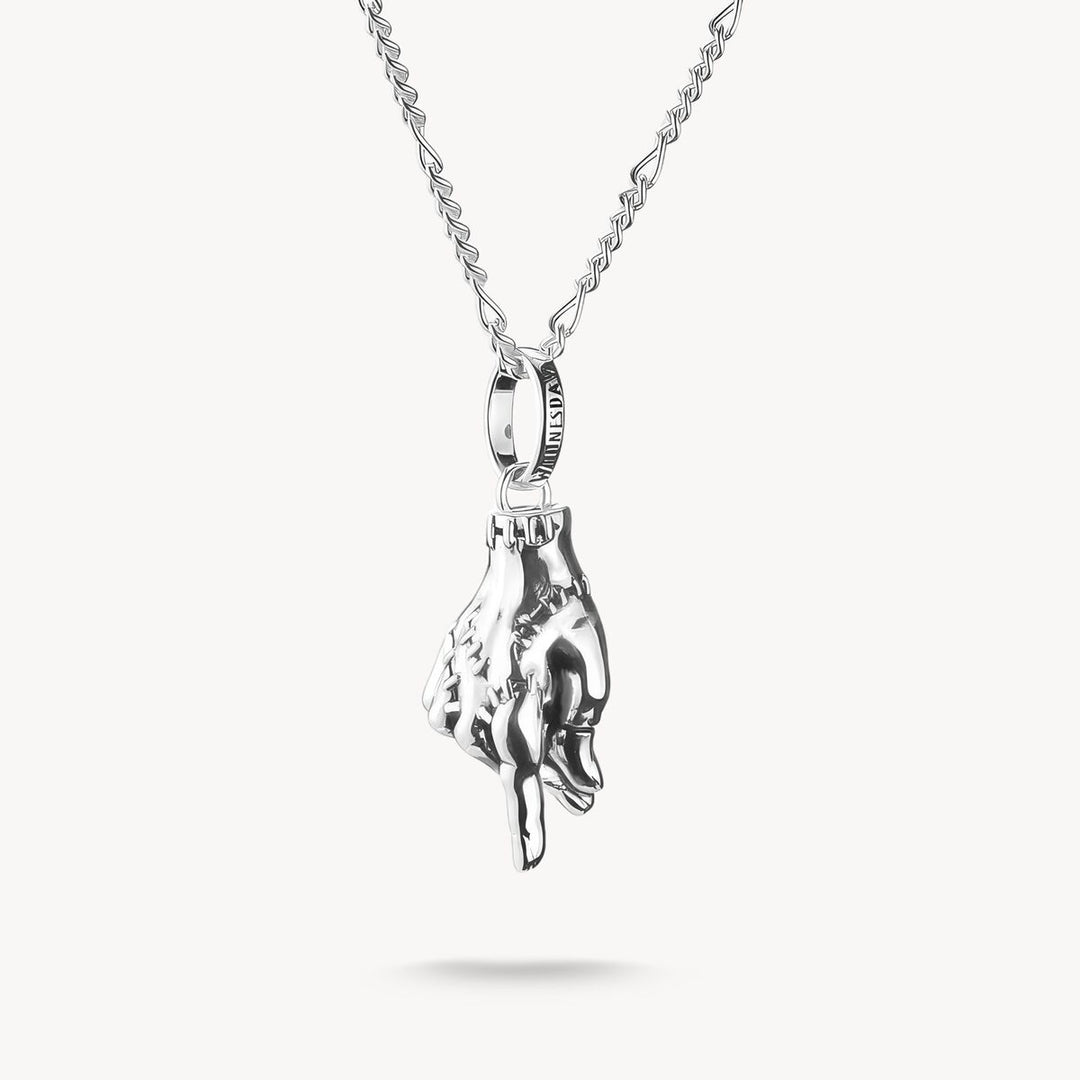 Silver hand-shaped pendant on a chain against a white background