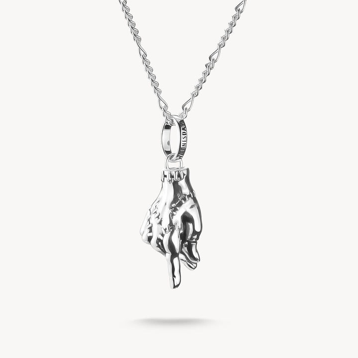 Silver hand-shaped pendant on a chain against a white background