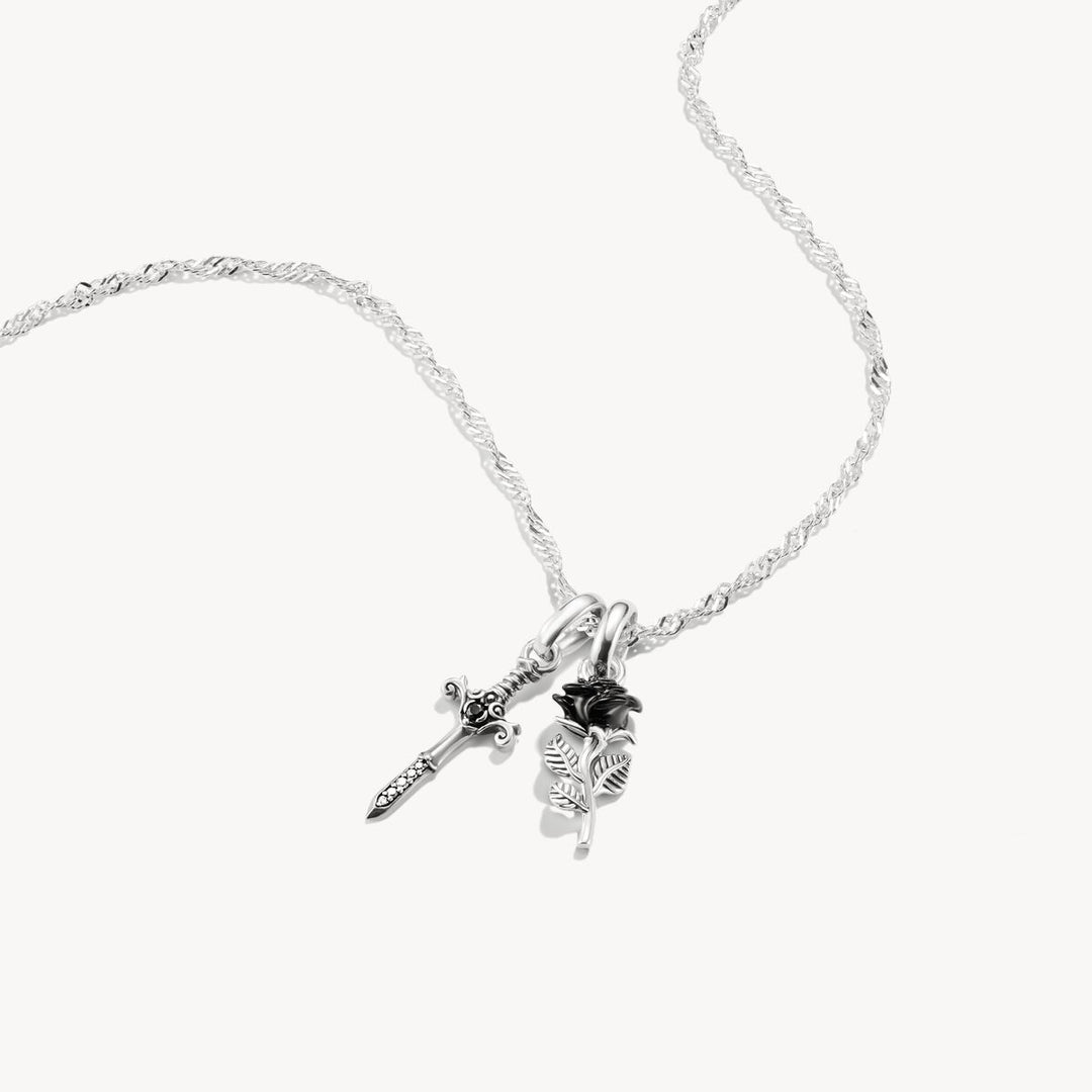 Silver necklace with floral pendant on a white background