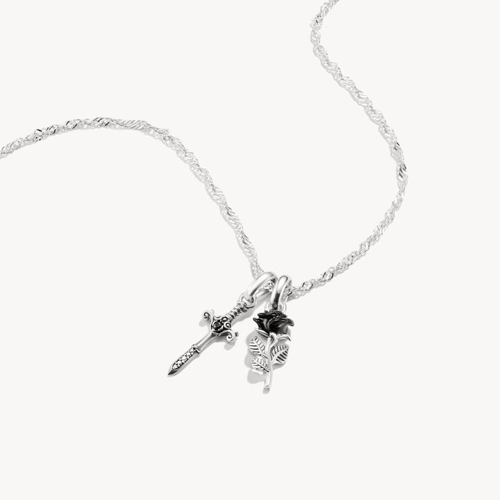 Silver necklace with floral pendant on a white background
