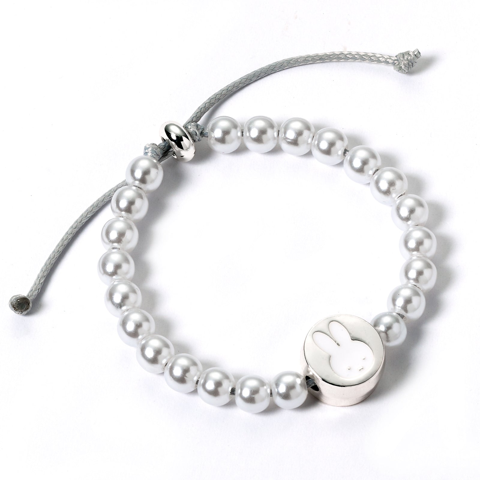 Pearl bracelet with a silver bunny charm on a white background