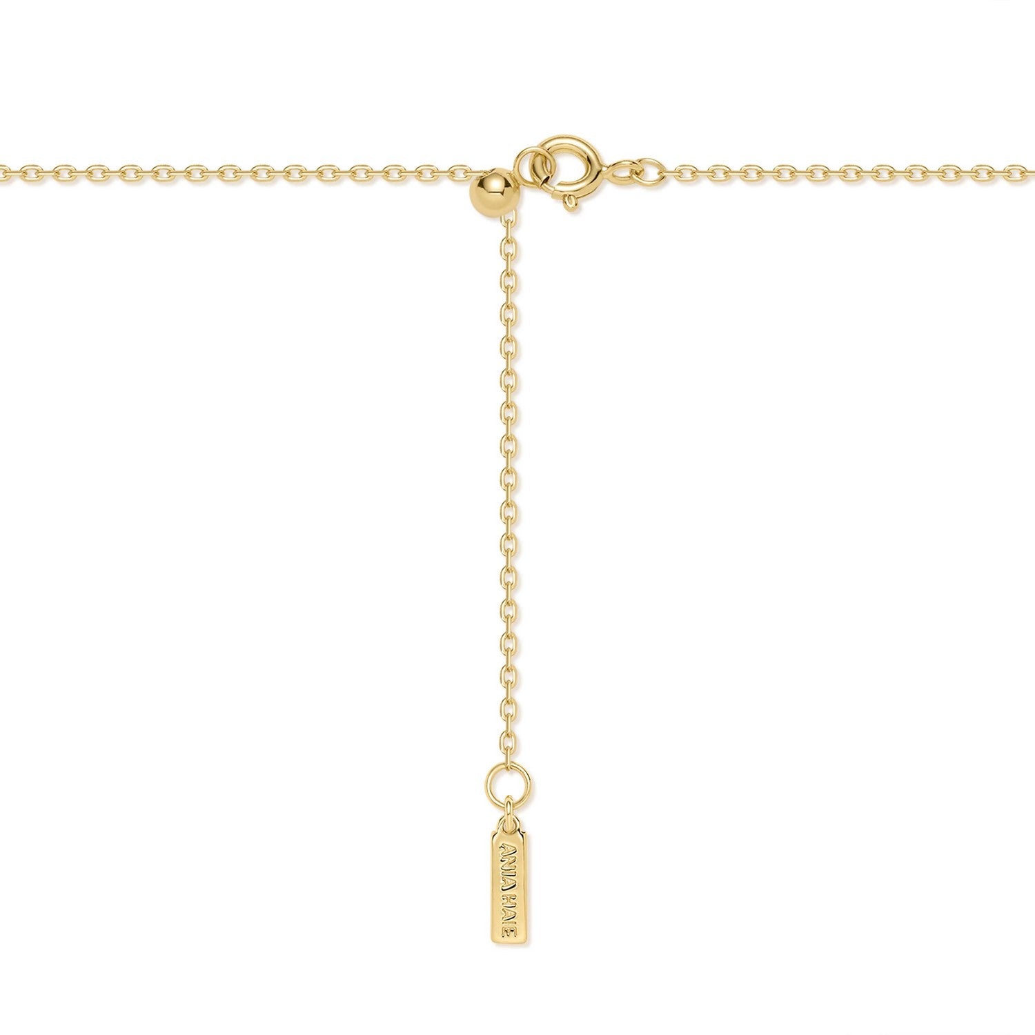 Gold necklace with a tag on a white background
