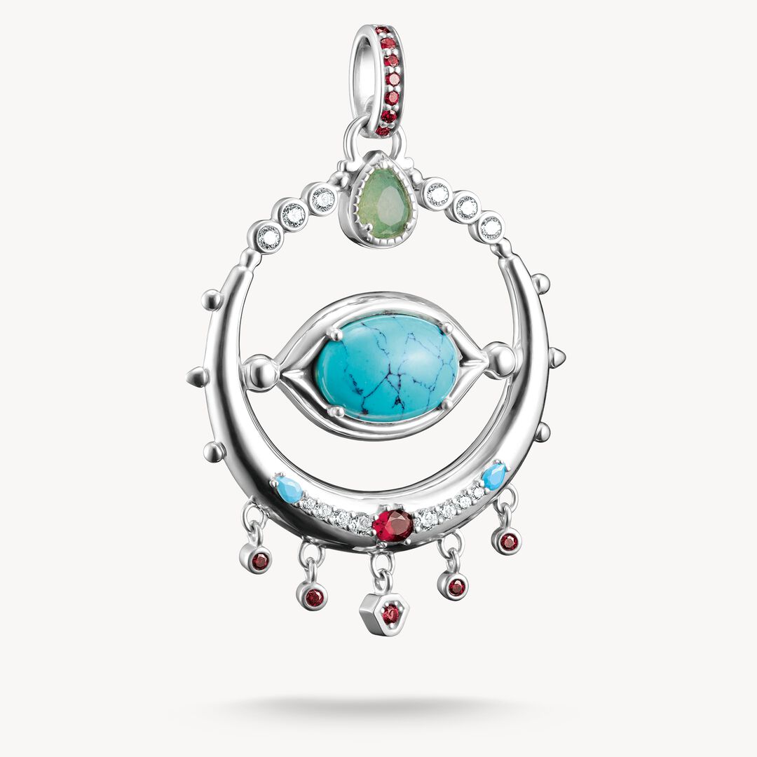 Silver pendant with turquoise stone and red gemstones on a white background