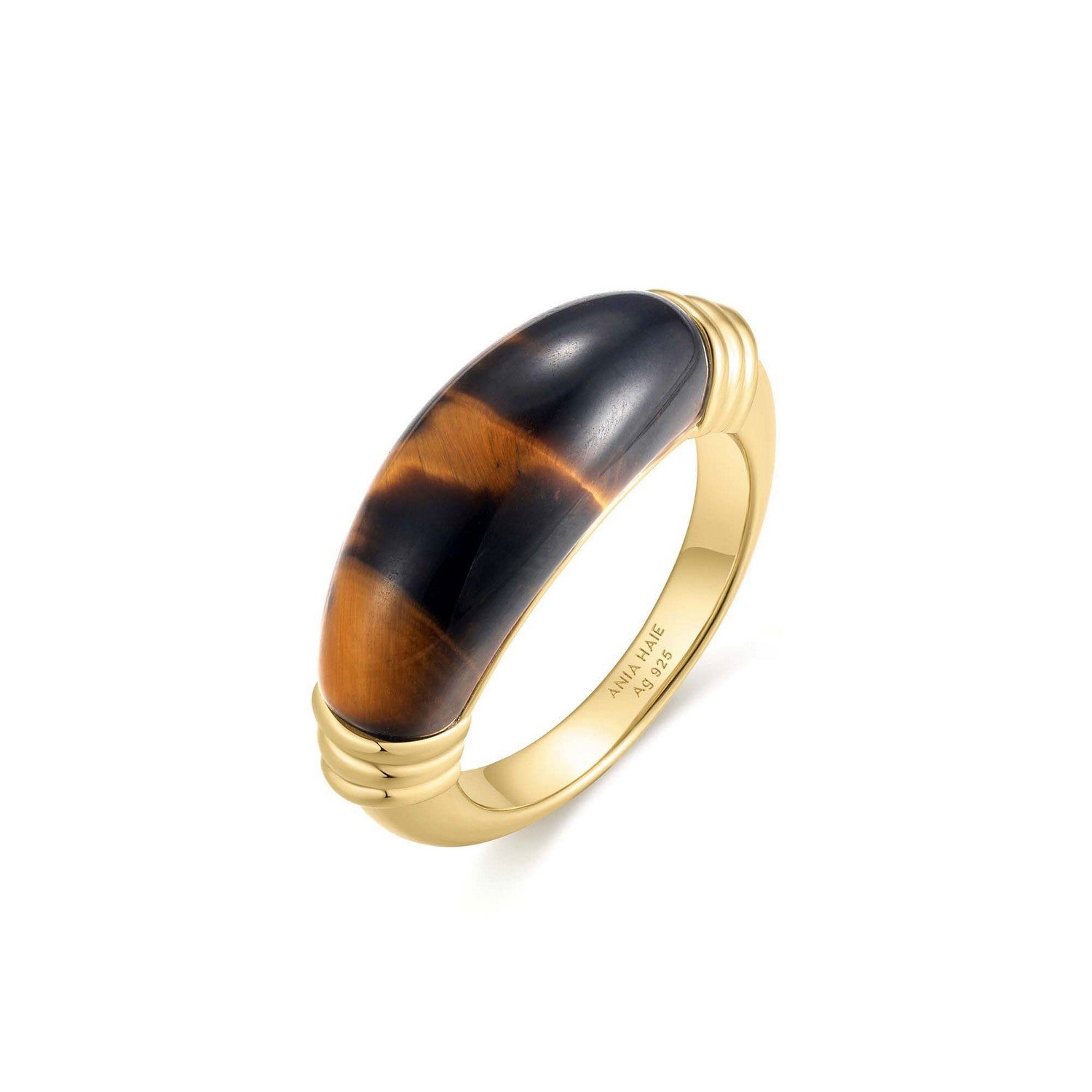 Gold ring with a tortoiseshell band on a white background