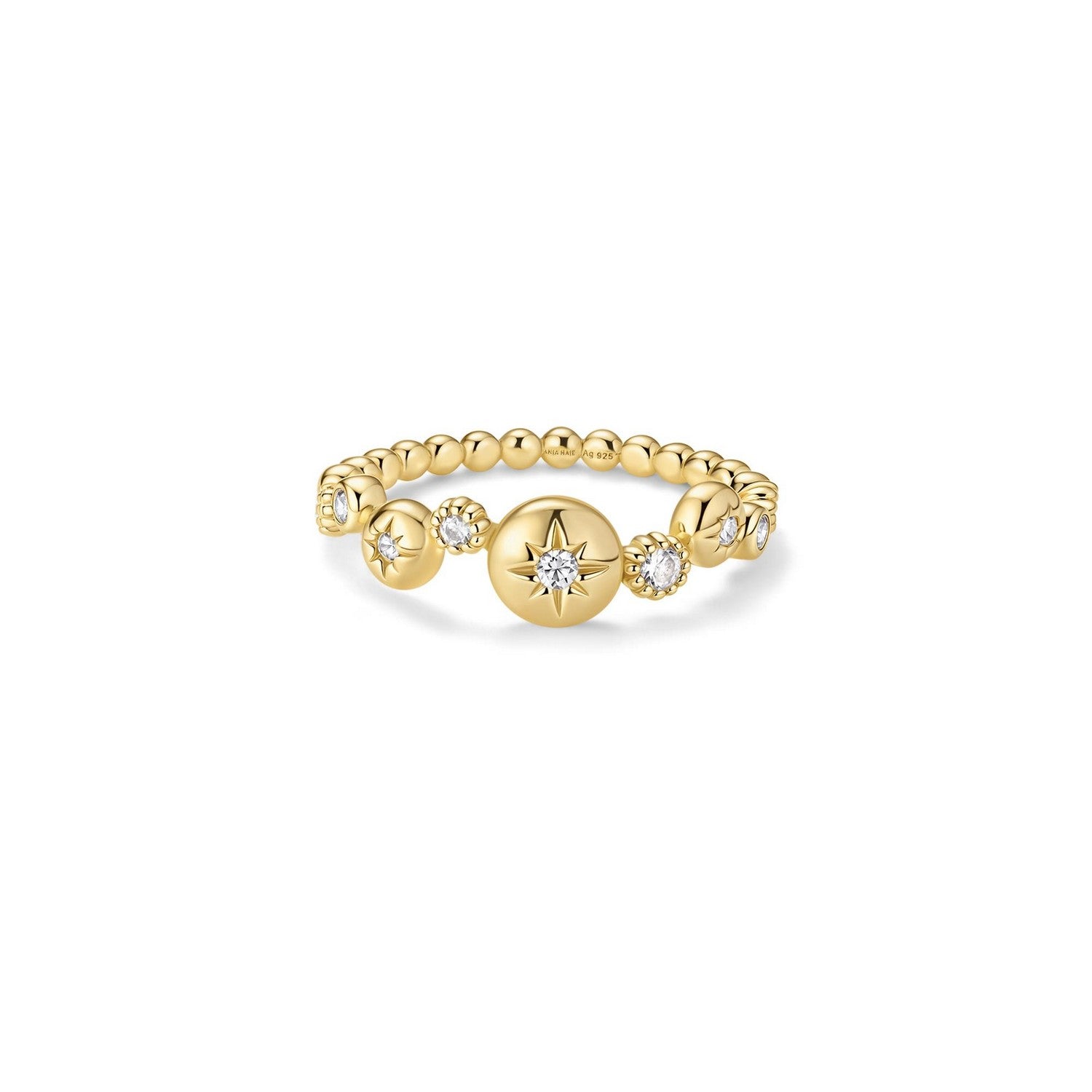 Gold ring with star-shaped beads on a white background