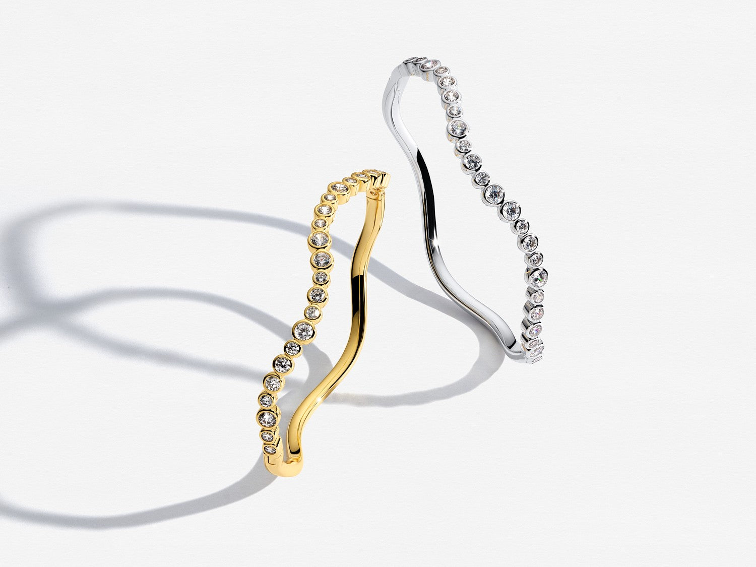 Gold and silver hoop earrings on a white background