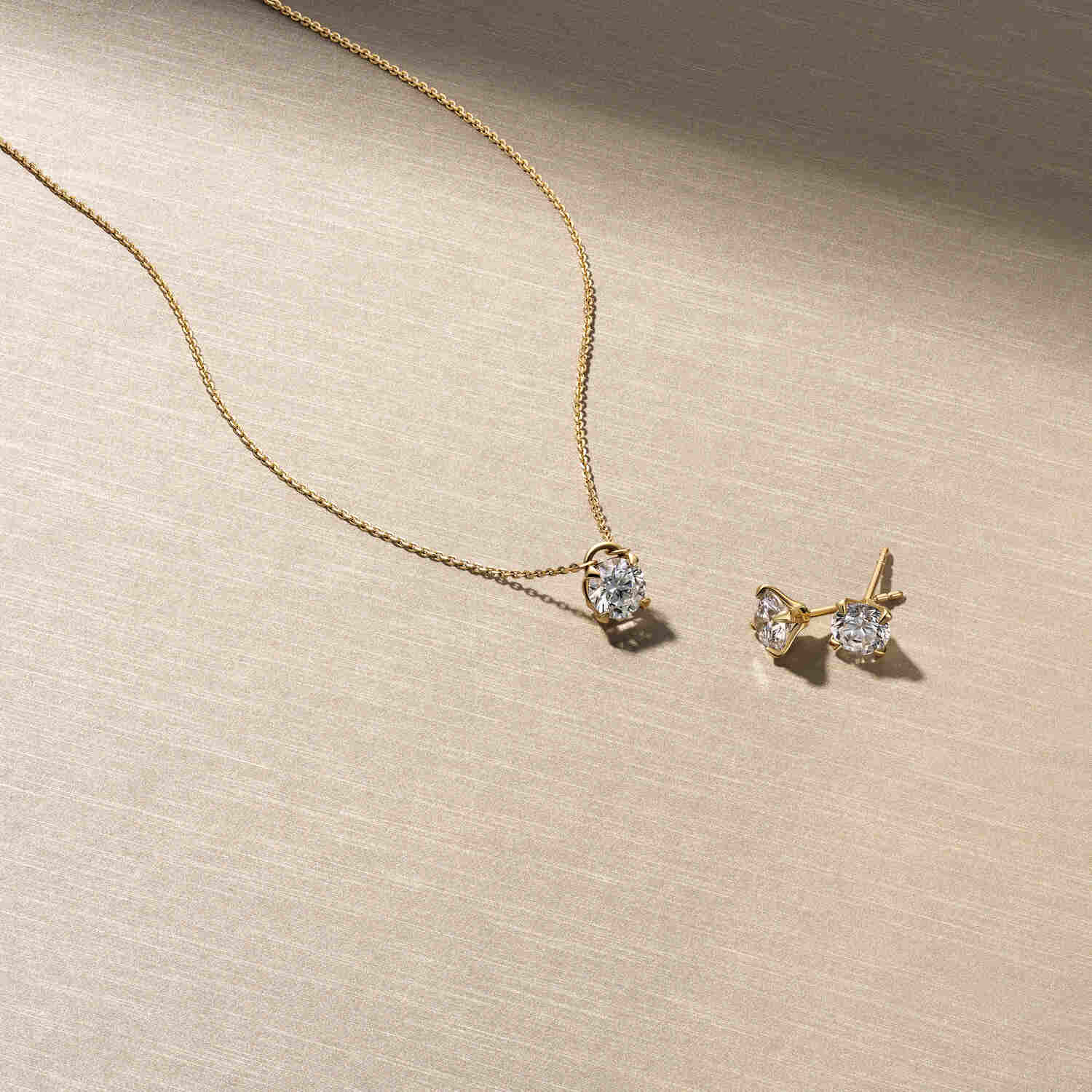 14k White Gold Venice Piccolo Single Diamond Earring SJ-E2501-WD-WG-1 elegantly displayed alongside a matching necklace, showcasing the exquisite design and sparkling lab-grown diamond, ideal for luxury jewelry collections featuring stunning earrings.