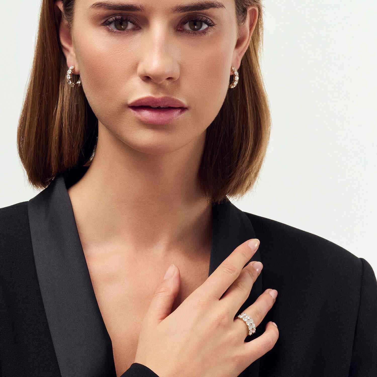 Model elegantly showcasing the 14k Yellow Gold Ariccia Diamond Earrings SJ-E2528-WD-YG paired with a sophisticated outfit, emphasizing the luxury and style of these exquisite earrings.