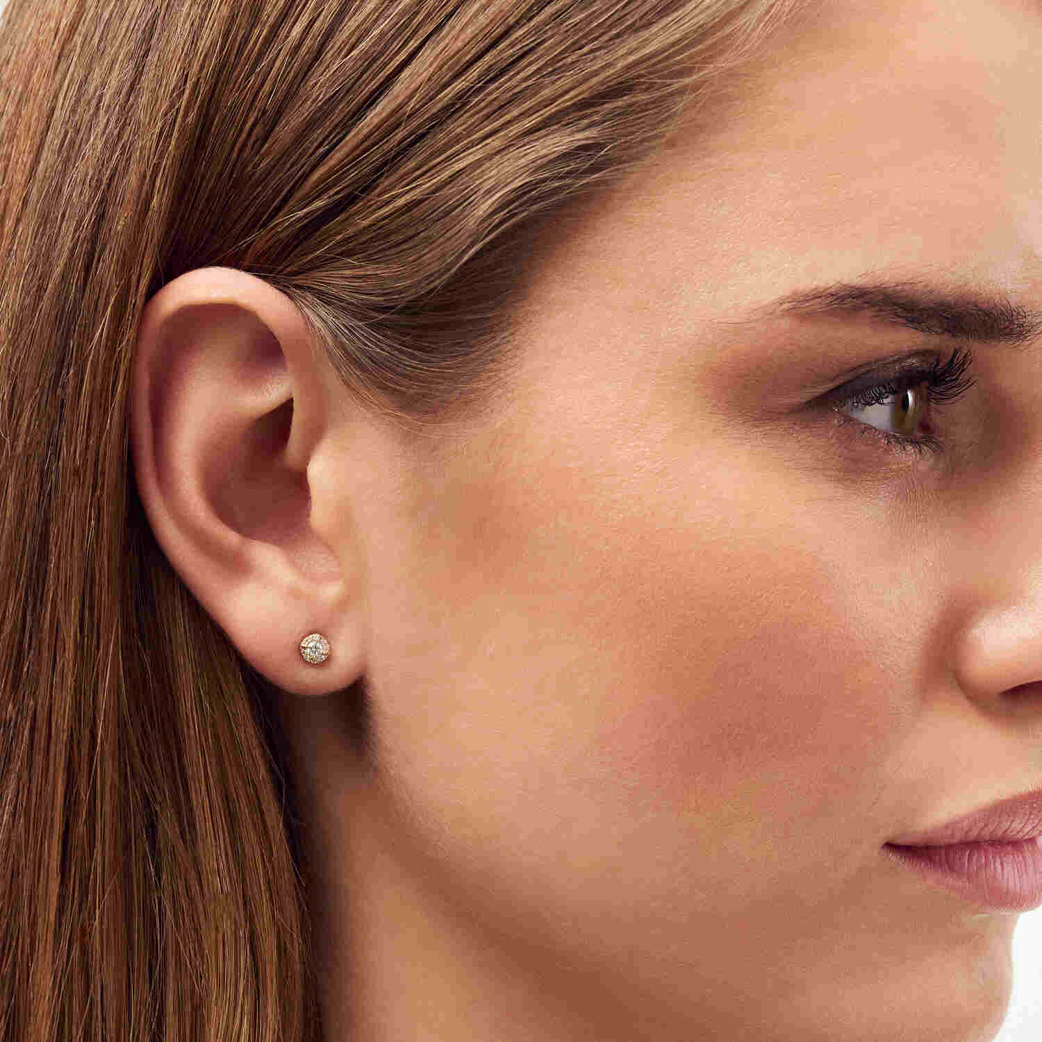 Close-up view of a model wearing 14k Yellow Gold Rome Diamond Earrings SJ-E2555-WD-YG, highlighting the elegant sparkle of these luxurious earrings.
