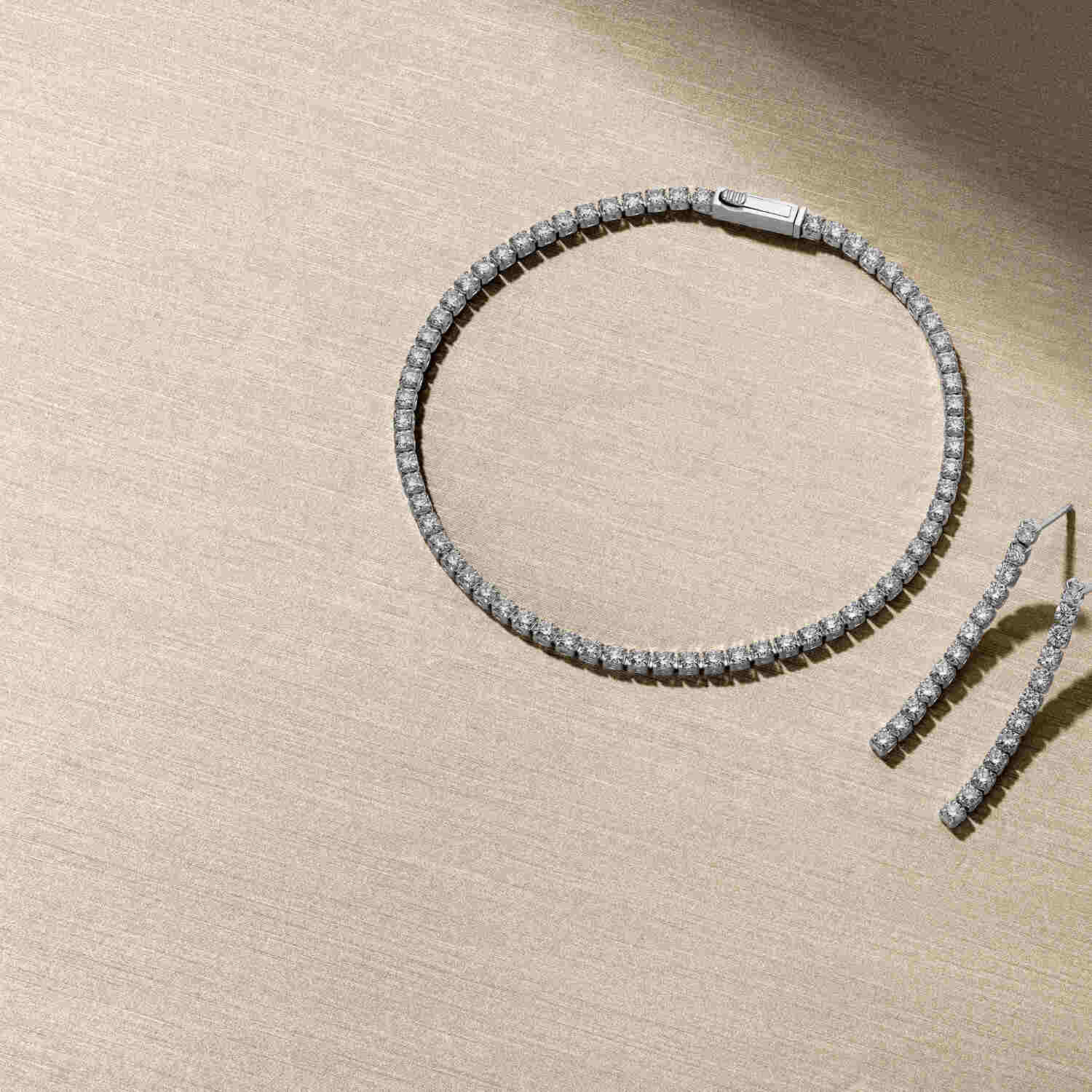 Elegant presentation featuring the 14k White Gold Diamante Diamond Earrings SJ-E2560-WD-WG alongside a matching diamond necklace, showcasing the brilliance of luxury jewelry.