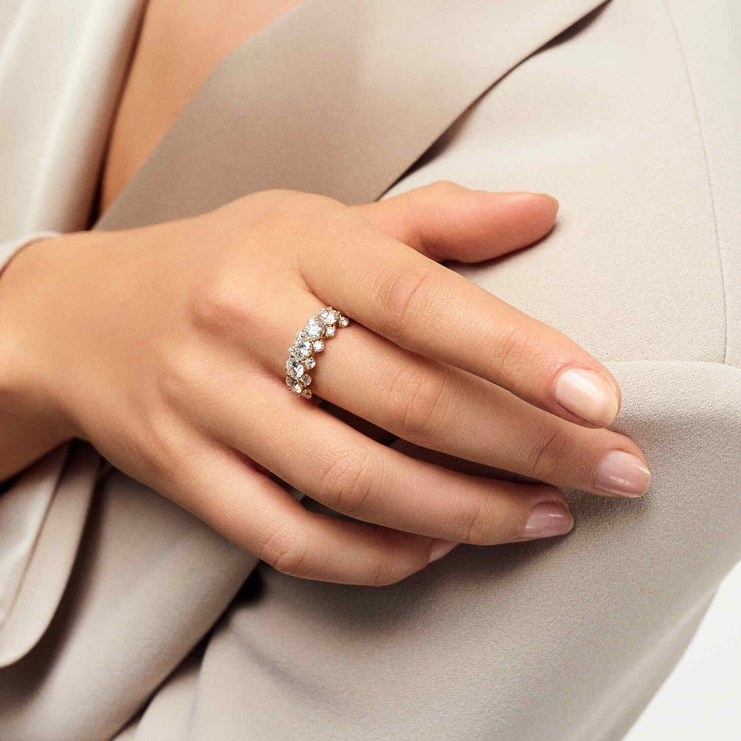 A hand adorned with the 14k Yellow Gold Fior Diamond Ring SJ-R2525-WD-YG, highlighting its beautiful design and shimmering diamonds, perfect for adding a touch of luxury.