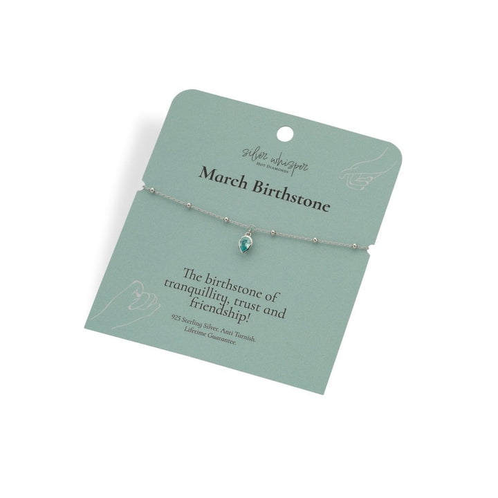 Silver bracelet with a green gemstone on a green card with text about March birthstone