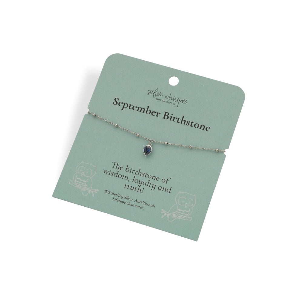 Silver bracelet with a heart-shaped gemstone on a green card with text about September birthstone.