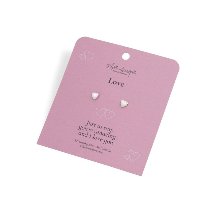 Heart-shaped earrings on a pink card with 'Suffie Wasserman' branding