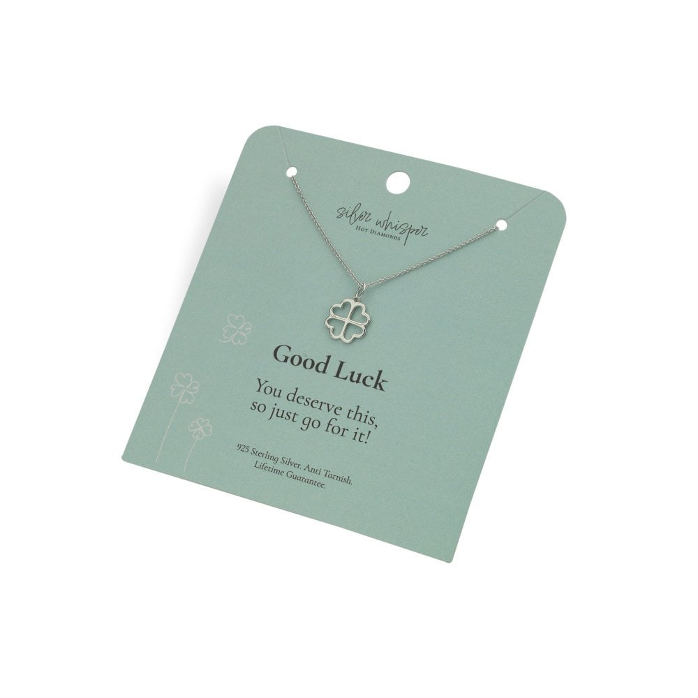 Silver necklace with clover pendant on a green card with 'Good Luck' message