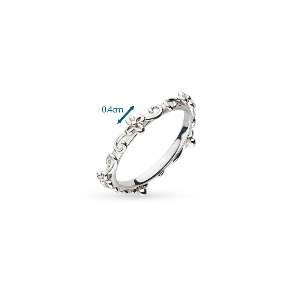 Silver ring with intricate design on a white background