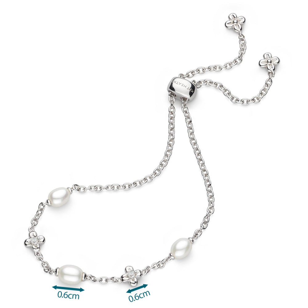 Silver bracelet with pearls and floral charms on a white background