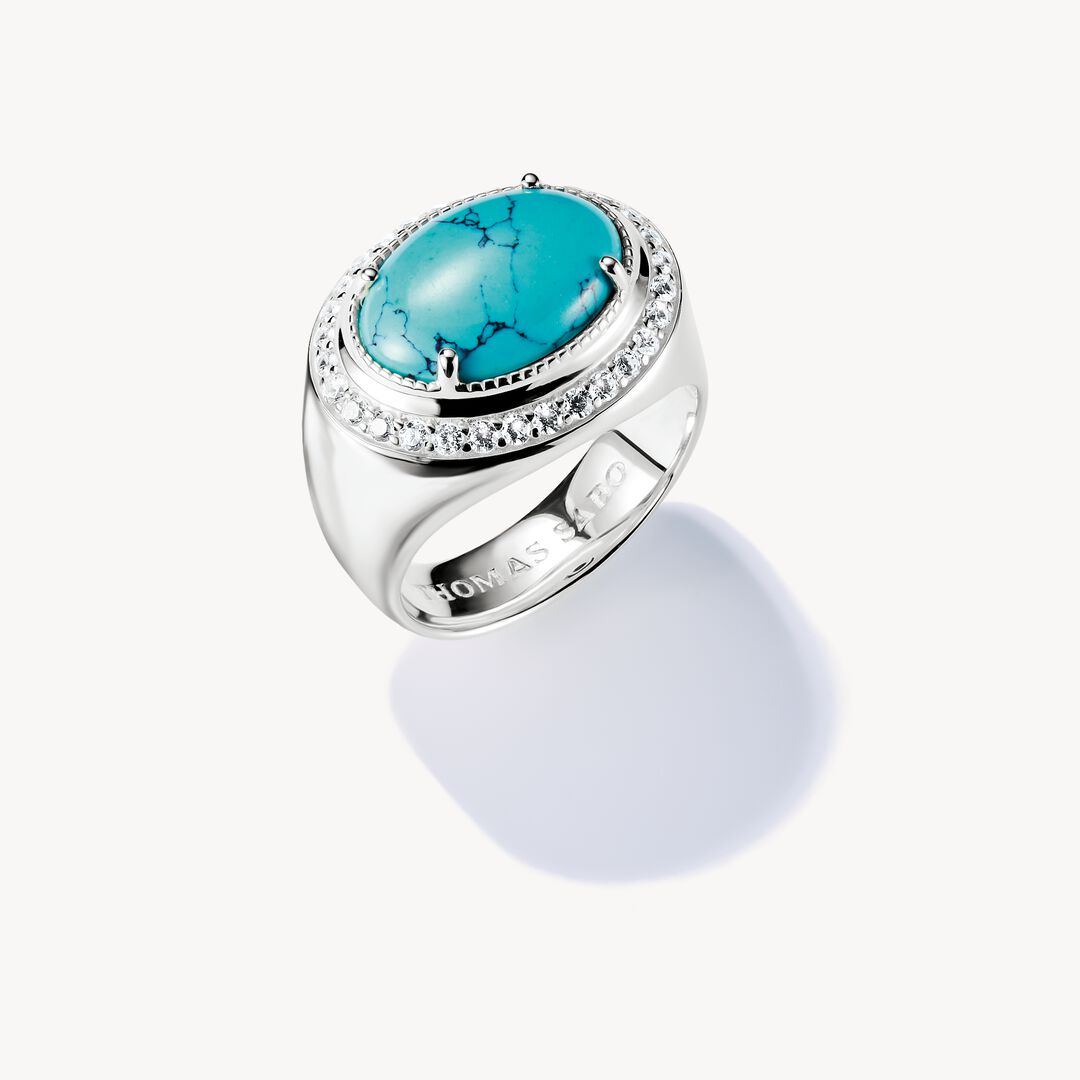 Silver ring with a turquoise stone on a white background