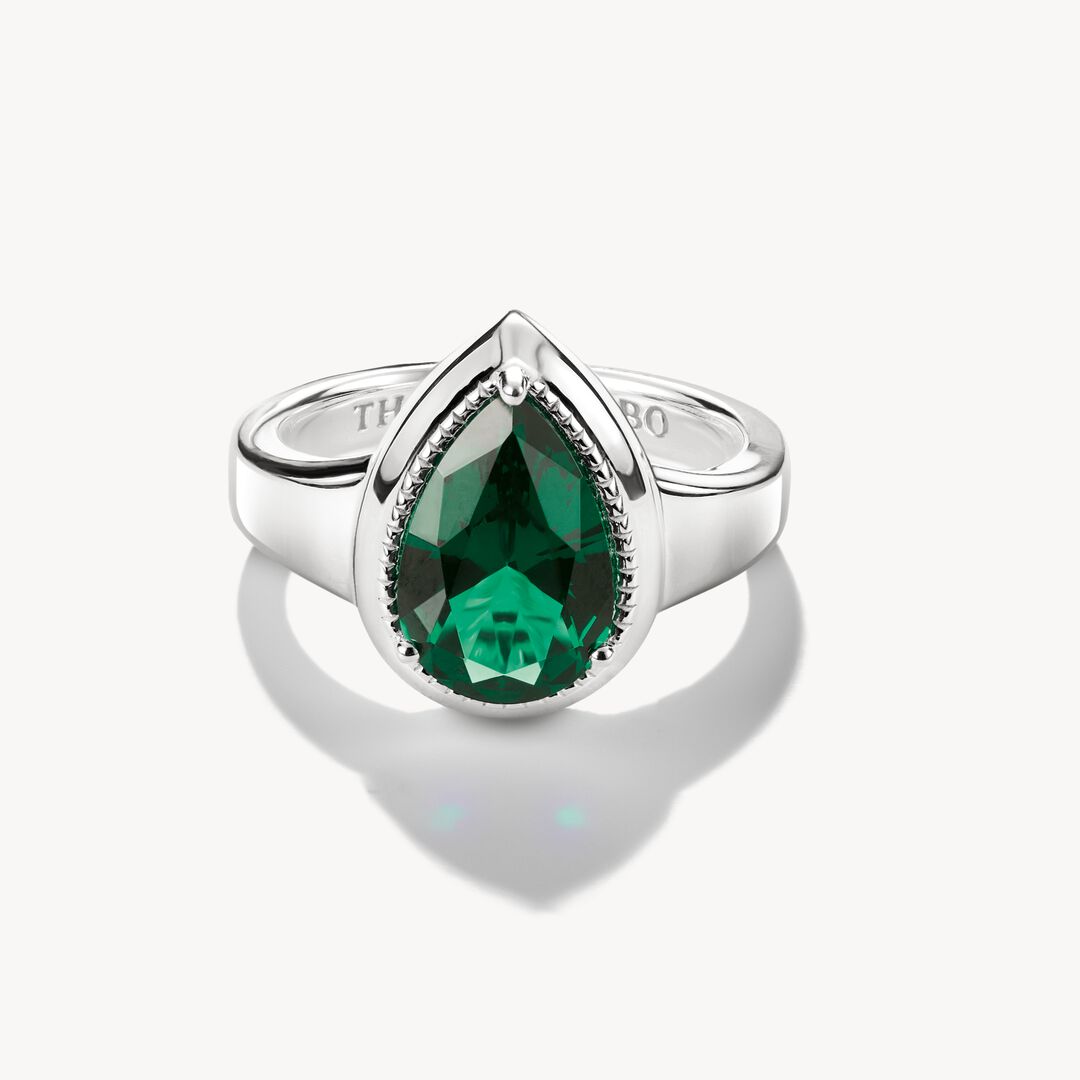 Silver ring with a green gemstone on a white background