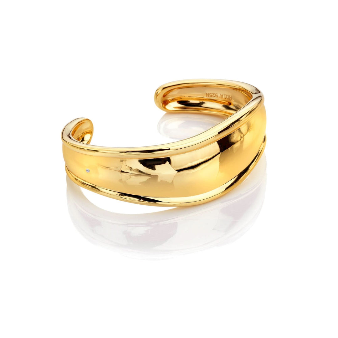 a close up of a gold ring on a white background